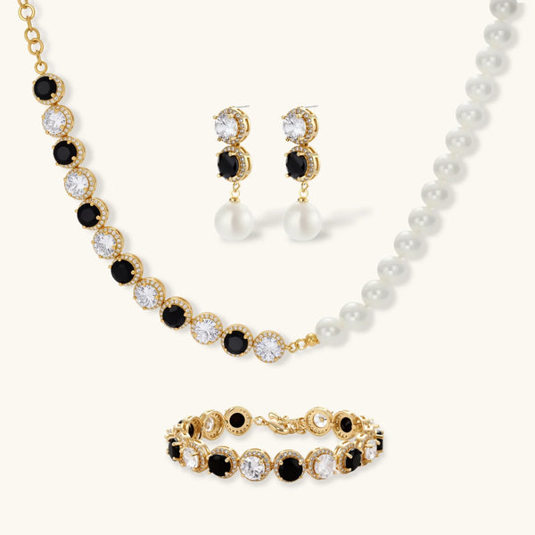 Gold-plated jewelry set with alternating black and clear cubic zirconia stones, featuring necklace, earrings and bracelet