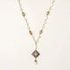 Y-shaped necklace with freshwater pearls, gold filigree stations, and ornate diamond-shaped centerpiece with pearl drop