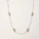 Long gold chain necklace with baroque pearls wrapped in leaf designs and small freshwater pearls spaced along the strand