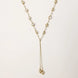 Adjustable gold lariat necklace with freshwater pearls nested in delicate cage settings and Y-shaped tassel drop