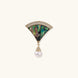 Gold fan-shaped brooch with iridescent abalone shell center, crystal border, and dangling white pearl on cream background