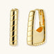 Chunky segmented gold-plated huggie hoop earrings with bamboo-inspired geometric design on white background.
