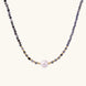 Dainty necklace with faceted purple iolite beads, gold vermeil accents, and central pink-white freshwater pearl.