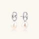 Modern rhodium-plated silver earrings with geometric double-circle design and freshwater pearl drops