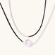 Double-strand necklace with black faceted quartz and white pearls featuring an oversized baroque pearl centerpiece