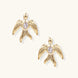 Gold-plated brass earrings shaped as doves in flight with lavender zirconia oval stones at center and textured wing details