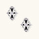 Pair of Art Deco-style stud earrings with star crystals, black enamel accents, and white gold plating on ivory background.