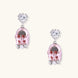 Drop earrings featuring miniature translucent handbag charms with heart crystal studs, silver bow accents, and pearls
