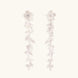 Long sterling silver drop earrings with delicate floral vine design and crystal accents on white background