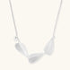 Minimalist sterling silver necklace with three brushed leaf-shaped pendants on delicate chain against white background