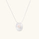 Sterling silver disc necklace with textured finish and centered freshwater pearl on delicate chain