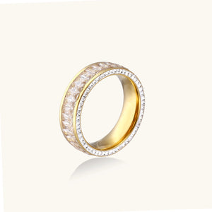 14K gold-plated ring with dual rows of clear baguette and round zirconia stones on cream background.