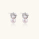 White gold stud earrings with square crystal stones in twisted frames and pink freshwater pearl drops below