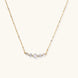 Delicate 14K gold-plated necklace with five graduated zirconia stones arranged in a curved arc on fine chain