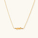Dainty 18K gold plated necklace with infinity knot pendant on delicate chain against white background
