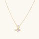 Gold-plated butterfly pendant with iridescent mother of pearl inlay on delicate chain against cream background.