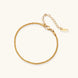 Delicate 18K gold-plated stainless steel bracelet with textured beaded chain on cream background