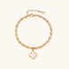 18K gold-plated oval bead chain bracelet with quatrefoil clover charm featuring mother of pearl inlay on cream background