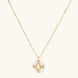 Gold-plated necklace with circular white enamel pendant featuring central zirconia stone and ornate decorative details