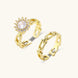 Two adjustable gold rings: chain-link band and halo-style ring with cubic zirconia stones on cream background